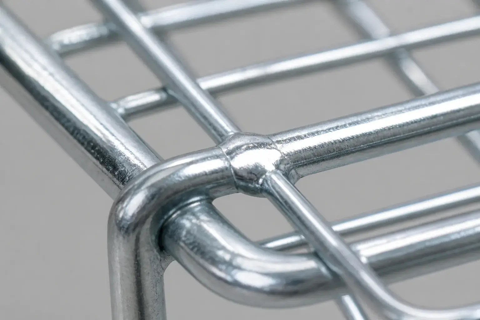 Zinc plated and sprayed finish on supermarket trolley wire basket showing coating coverage at the weld joints